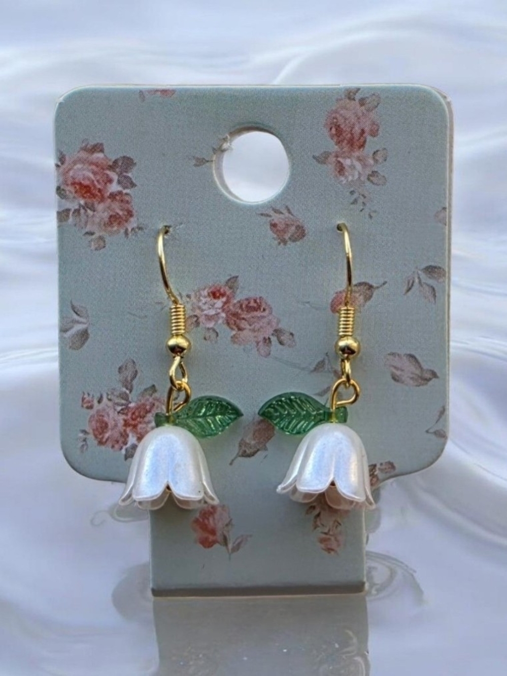 Gold-Tone White Flower Drop Earrings with Green Leaf Accent